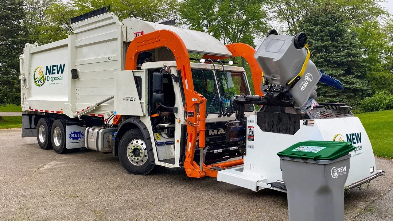 NEW Disposal truck lifting a residential cart curbside